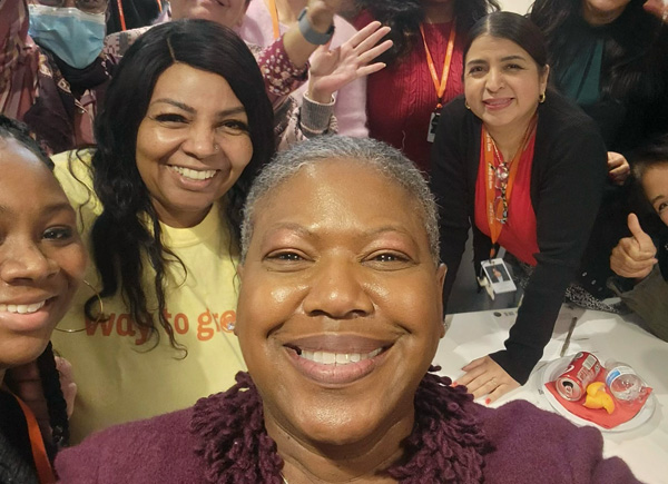 Group selfie with several smiling women at an event